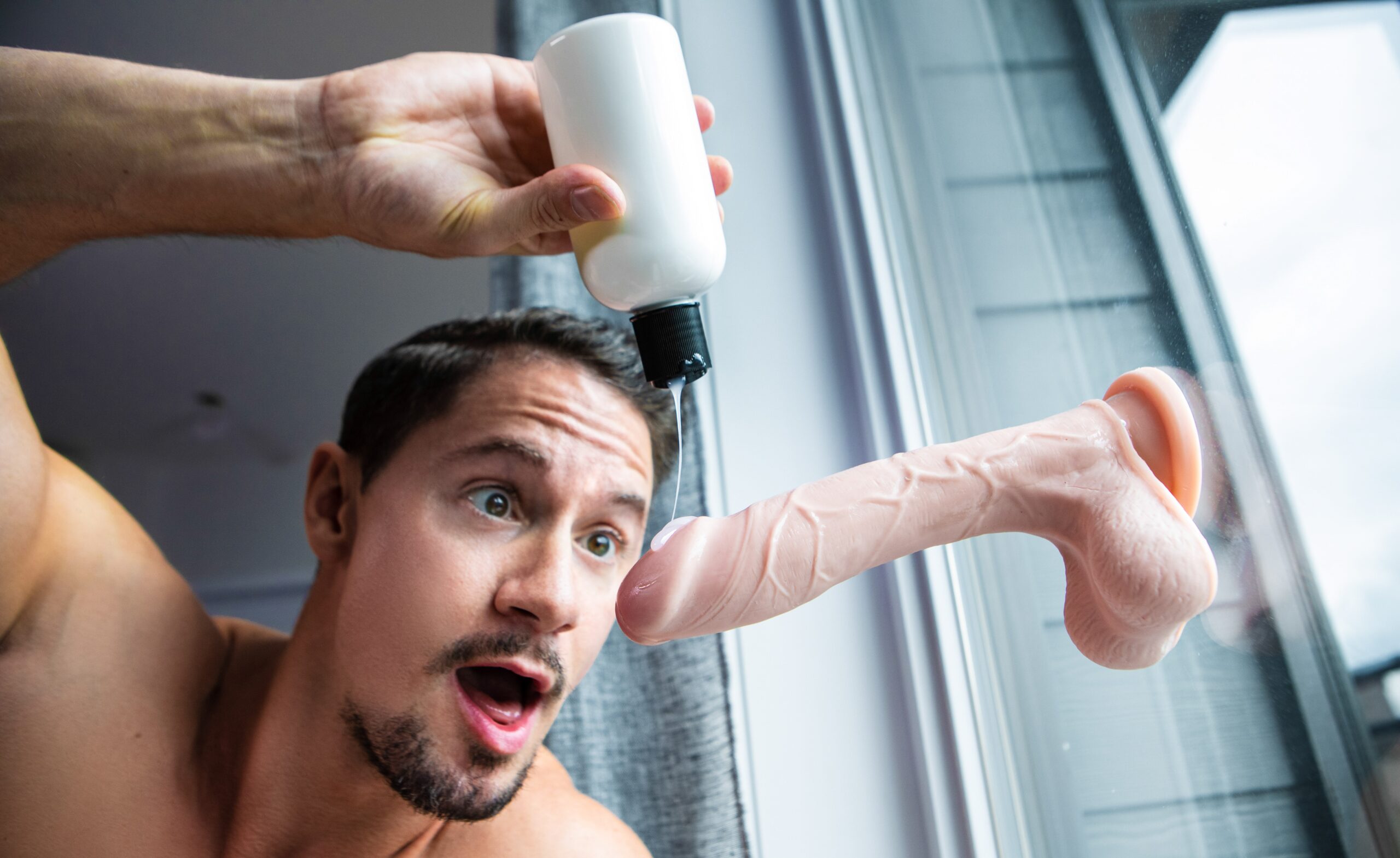 skyy knox lubing up a suction dildo on window for men.com