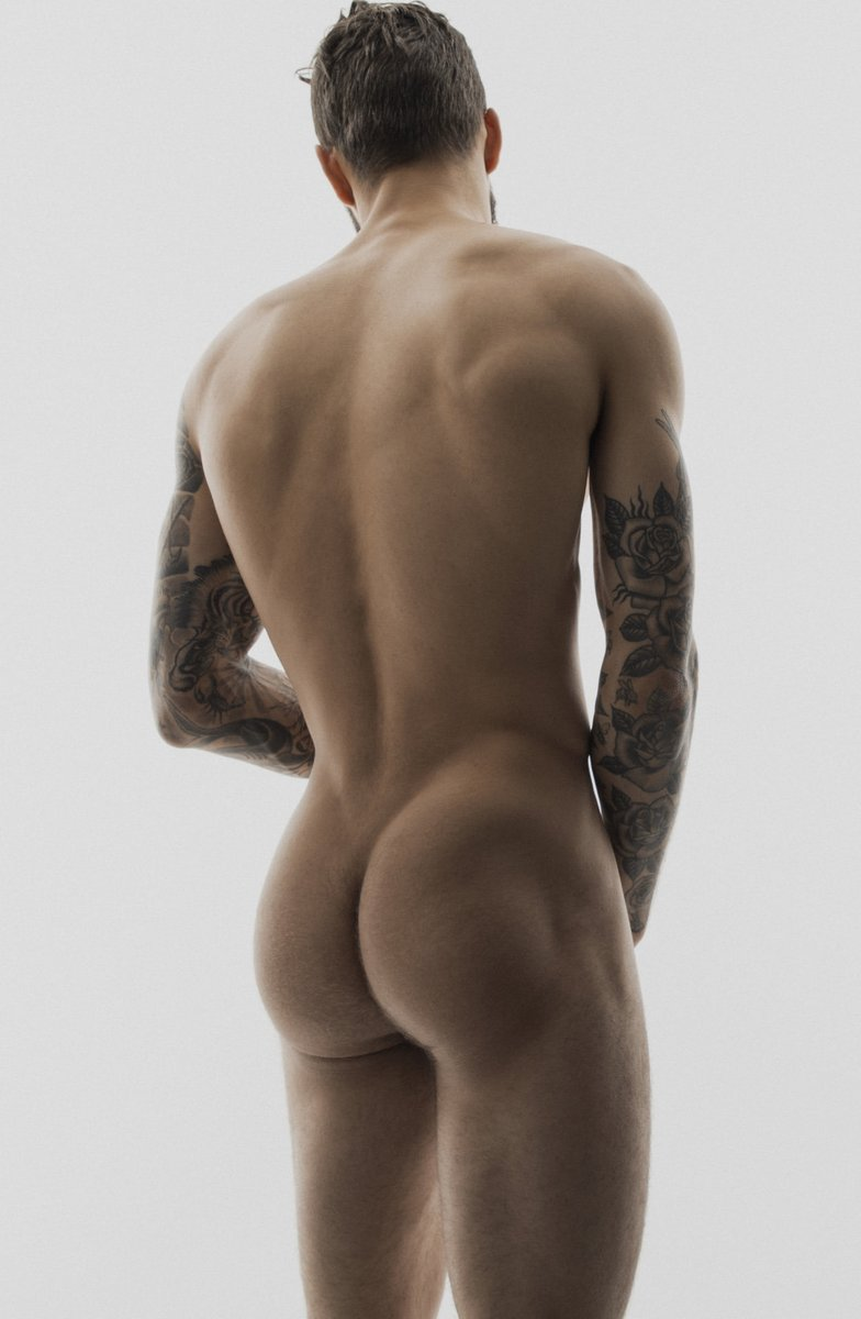 Gay male with half sleeve tattoos taking sensual gay ass selfie with his face away from the camera