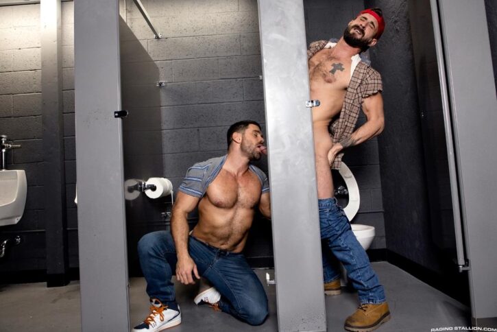 gay male getting his cock sucked by gay xxx porn actor at local bathroom gloryhole ready to bust his hot thick load all over his hookup partner's face for ragingstallion.com gay xxx porn promo photo